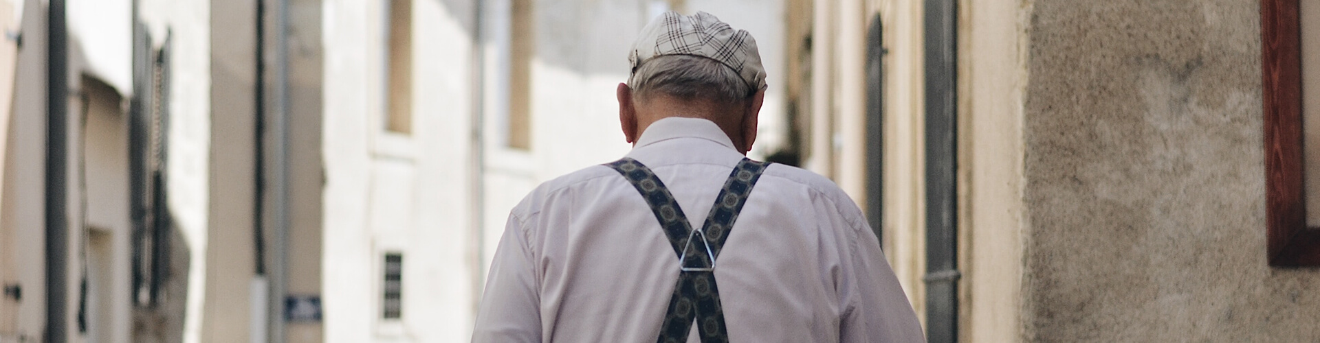 elderly man walking through town
